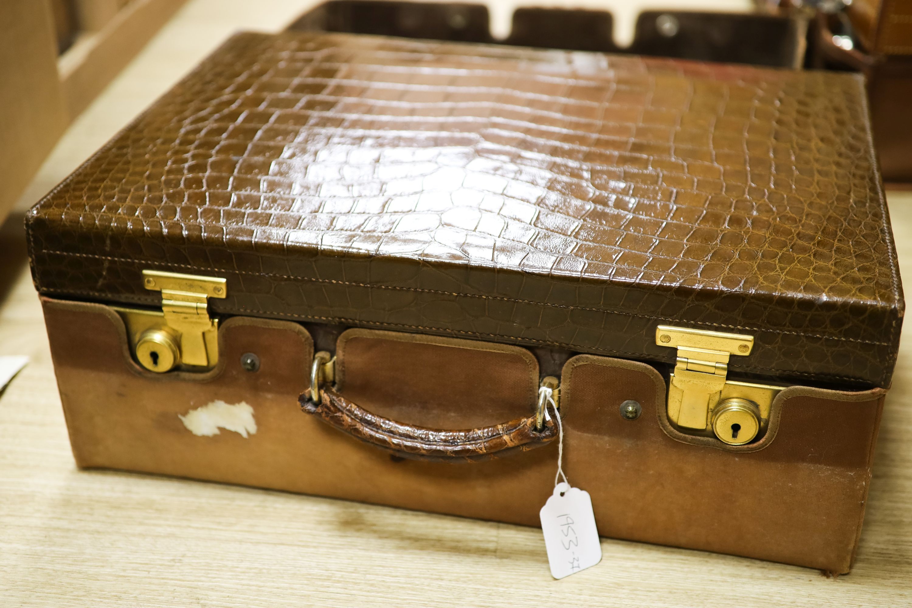 A George V crocodile skin travelling toilet case with ten engine turned silver mounted silver fittings, George Betjemann & Sons Ltd, London, 1927/8, case 50.7cm.